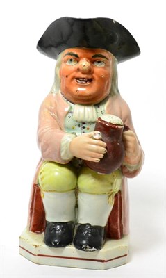 Lot 171 - A pearlware Toby Jug, early 19th century, of traditional form holding a jug and pipe