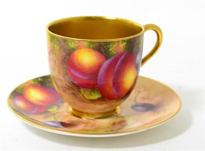 Lot 180 - A Royal Worcester coffee cup and saucer, 1938, painted by Harry Ayrton with a still life of fruit