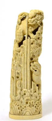 Lot 183 - A Japanese ivory okimono, Meiji period, as a lion dog, a tiger and a snake on a mountain, 21cm high