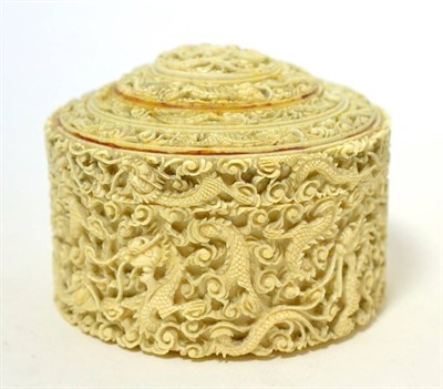 Lot 189 - A Cantonese ivory circular box, mid 19th century, carved with a profusion of flowers, 13cm diameter