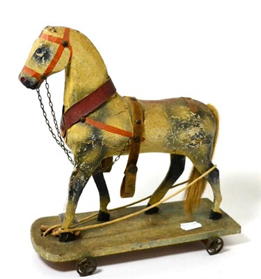 Lot 232 - A 19th century German painted wood model of a horse and delivery cart, the horse on a wheeled base