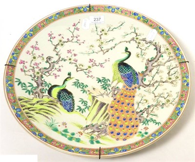 Lot 237 - A Japanese porcelain charger, circa 1900, painted in Chinese style with peacocks amongst...